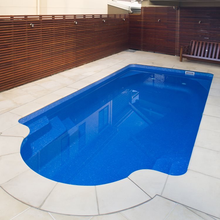 Roman-end freeform fibreglass pool with a sandstone surround